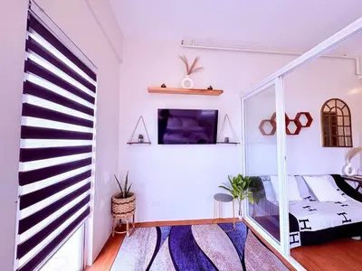 a white room with a bed and a window at Minimalist Condo near NAIA Free Netflix Pool Balcony in Manila