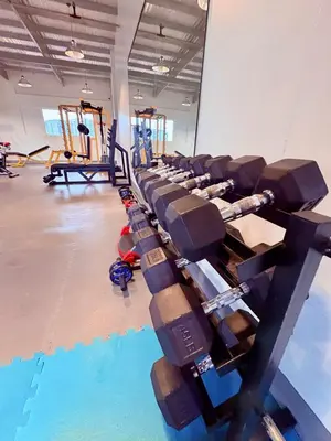 a gym with a row of dumbbells in a gym at Minimalist Condo near NAIA Free Netflix Pool Balcony in Manila