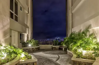 a building with a view of the city at night at La Verti Residences 1524 in Manila