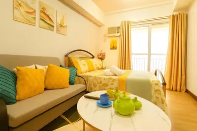 a living room with a couch and a table at La Verti Residences 1520 in Manila