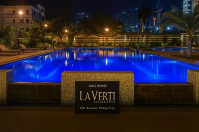 a large swimming pool with blue lighting at night at La Verti Residences 1520 in Manila