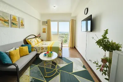 a living room with a couch and a table at La Verti Residences 1520 in Manila