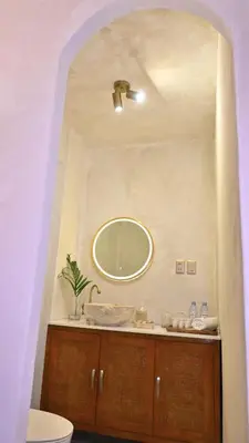 a bathroom with a sink and a mirror at Nusa Villa in Malinta