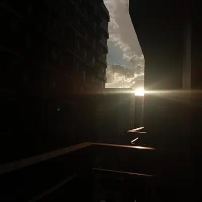 a view of a building with the sun in the sky at Modern MOA Escape, Work, Chill & City Views in Manila