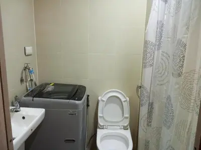 a small bathroom with a toilet and a sink at Comfort & Productivity Rainy Season WFH Retreat in Manila