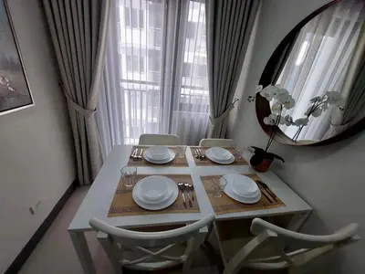 a dining room table with chairs and a mirror at Comfort & Productivity Rainy Season WFH Retreat in Manila