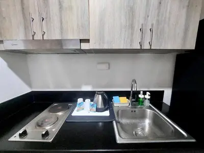 a kitchen counter top with a sink and a sink at Comfort & Productivity Rainy Season WFH Retreat in Manila