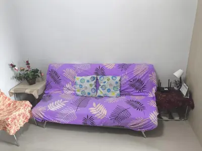 a purple couch with two pillows in a living room at Sea Residence-Rosa in Manila