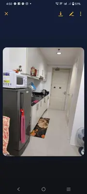 a small kitchen with a sink and a microwave at Sea Residence-Rosa in Manila