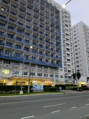 a large building with a sea sign in front of it at Sea Residence-Rosa in Manila