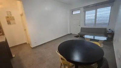 a living room with a black table and a couch at Nemar Building 204 in Manila