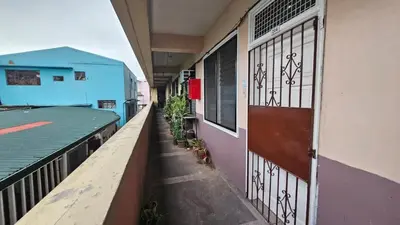 an empty hallway of a building with a door at Nemar Building 204 in Manila