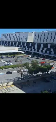 a large building with a parking lot in front of it at SMDC South Residences in Manila