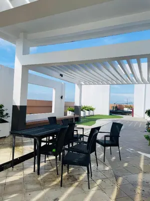 a patio with a table and chairs under a pavilion at Urbanstay at The Radiance Manila Bay in Manila