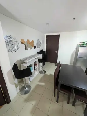 a room with a desk and a table and chairs at Lily s Place in Manila