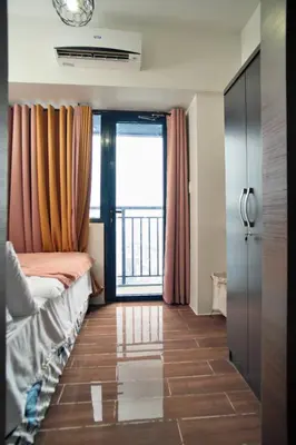 a room with a bed and a large window at The City View Air Residences Makati in Manila