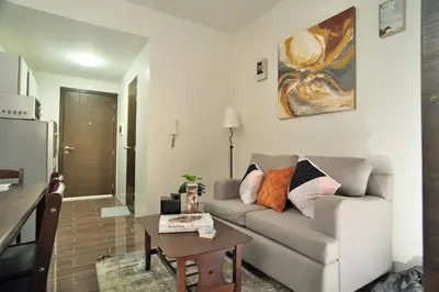 a living room with a couch and a table at The City View Air Residences Makati in Manila