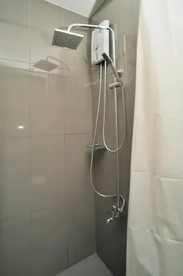 a shower with a shower head in a bathroom at The City View Air Residences Makati in Manila