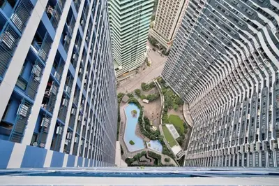 a view of a garden between two tall buildings at The City View Air Residences Makati in Manila