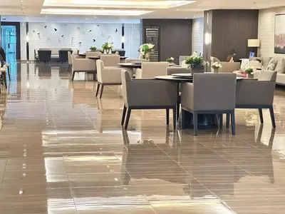 a restaurant with tables and chairs in a lobby at The City View Air Residences Makati in Manila