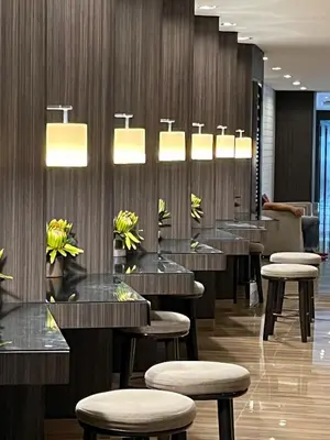 a row of tables and stools in a restaurant at The City View Air Residences Makati in Manila