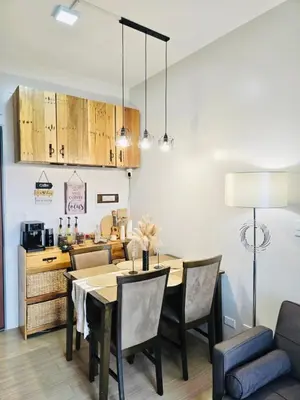 a kitchen and dining room with a table and chairs at The Hive Cozy 1-BR Retreat in Taytay