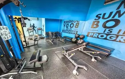 a gym with dumbbells and weights in a room at The Hive Cozy 1-BR Retreat in Taytay