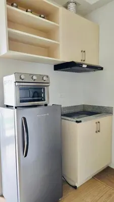 a kitchen with a stainless steel refrigerator and a stove at The Hive Cozy 1-BR Retreat in Taytay