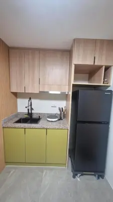 a kitchen with a sink and a black refrigerator at Kage-no-Wa Suite Netflix, Disney, HBO 2BR in Manila