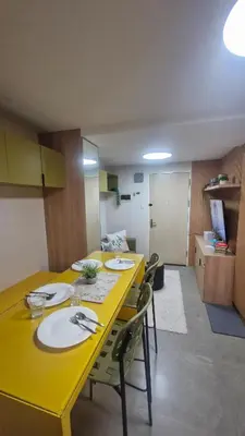 a yellow table and chairs in a room at Kage-no-Wa Suite Netflix, Disney, HBO 2BR in Manila