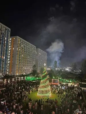a large crowd of people standing around a christmas tree at Kage-no-Wa Suite Netflix, Disney, HBO 2BR in Manila