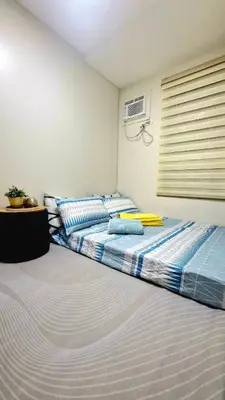 a bedroom with two beds and a window at Kage-no-Wa Suite Netflix, Disney, HBO 2BR in Manila