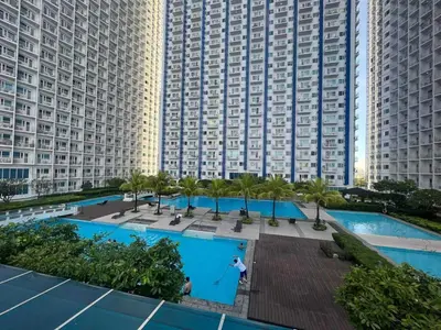 an aerial view of a large apartment building with two pools at SM Jazz Residences, Makati City in Manila