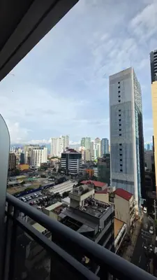 a view of a city from a balcony at Urban Retreat at The Gramercy Residences Makati in Manila