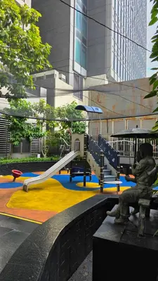a park with a playground with a slide at Urban Retreat at The Gramercy Residences Makati in Manila