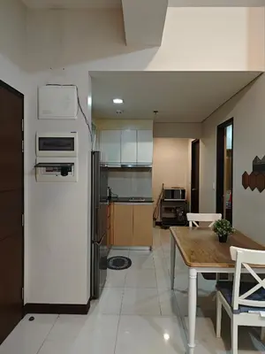 a large kitchen with a table and a refrigerator at RL airport haven in Manila