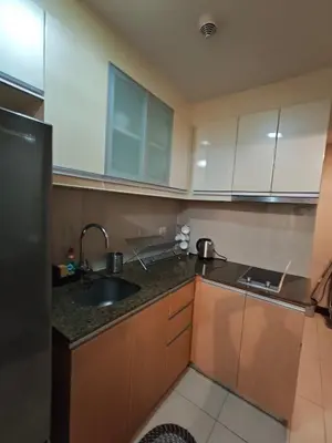 a kitchen with white cabinets and a sink at RL airport haven in Manila