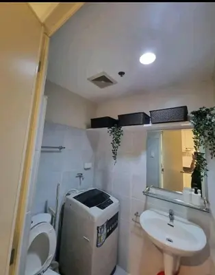 a bathroom with a toilet and a sink at cozy room at Sea Res in Manila