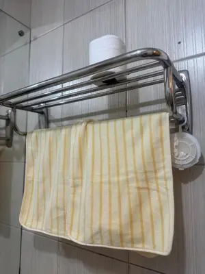 a towel is hanging on a towel rack in a bathroom at TGG Suites at Birch Tower in Manila