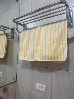 a towel hanging on a towel rack in a bathroom at TGG Suites at Birch Tower in Manila