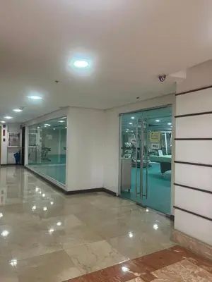 an empty lobby with glass doors in a building at TGG Suites at Birch Tower in Manila