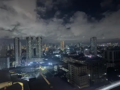 a view of a city at night with lights at TGG Suites at Birch Tower in Manila