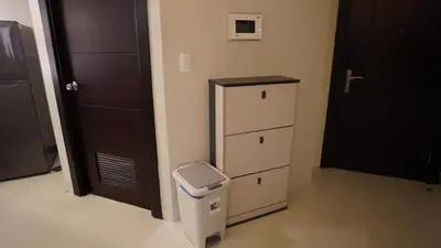 a room with a trash can next to a door at Luxury 2BR in Uptown Parksuites BGC Balcony & Prime location in Manila