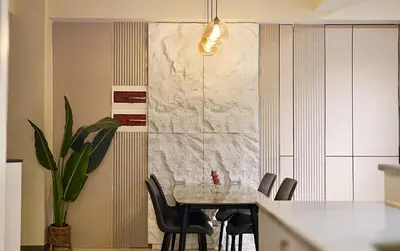 a dining room table with chairs and a marble wall at Luxury 2BR in Uptown Parksuites BGC Balcony & Prime location in Manila