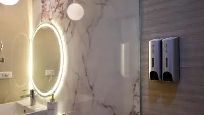 a bathroom with a mirror and a sink at Luxury 2BR in Uptown Parksuites BGC Balcony & Prime location in Manila