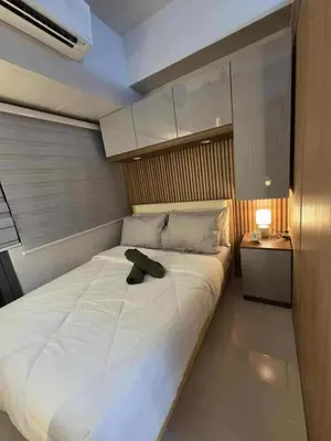 a bedroom with a white bed with a hat on it at Cozy Haven Suite at Shore 3 in Manila