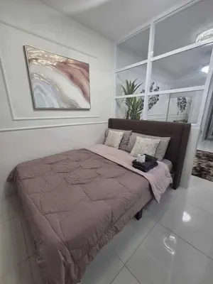 a bedroom with a large bed with a blanket at City Escape Haven in Manila