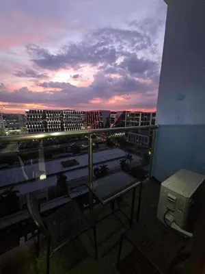 a balcony with a view of a city at dusk at City Escape Haven in Manila