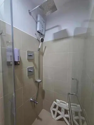 a shower stall in a bathroom with a shower at City Escape Haven in Manila