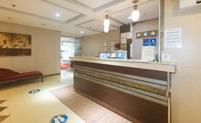 a restaurant with a counter in a room at The Shilla Philia Hotel by RedDoorz in Manila